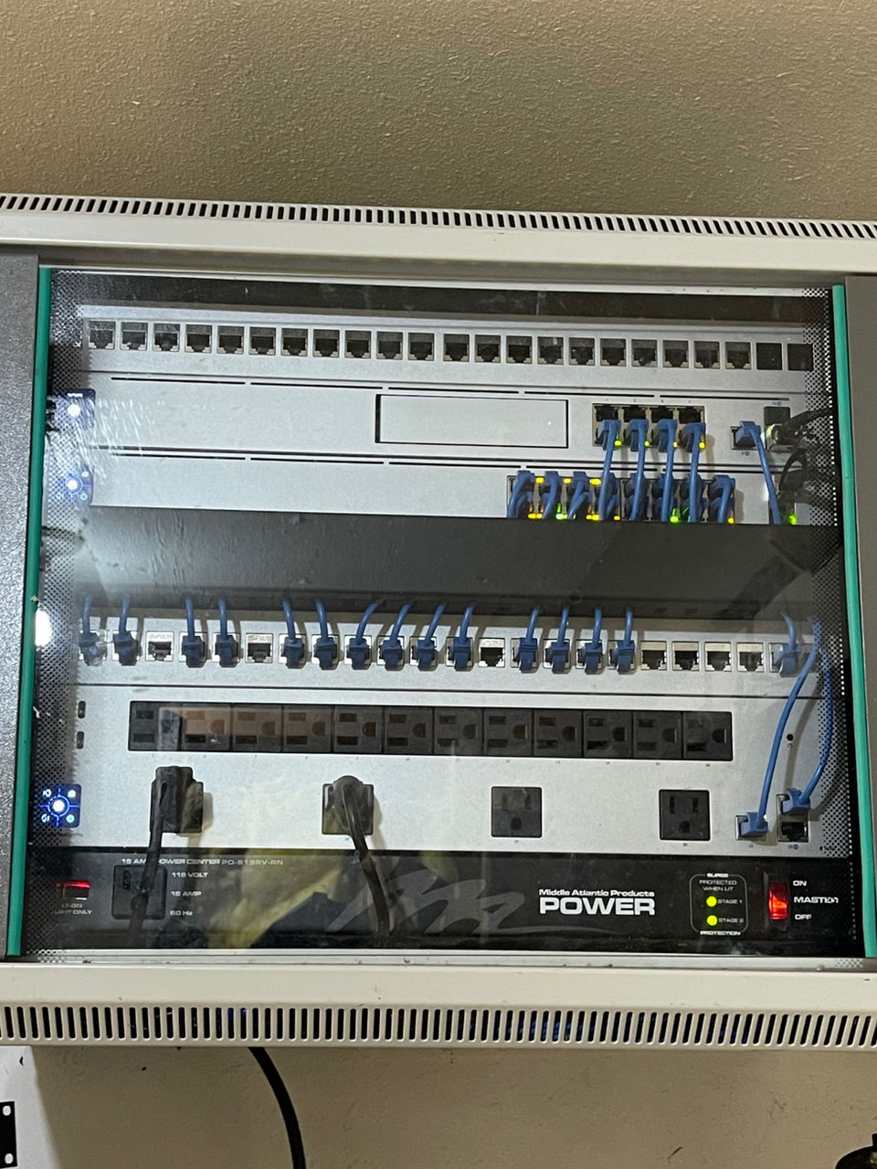 Organized network switches and cabling in a wall-mounted cabinet